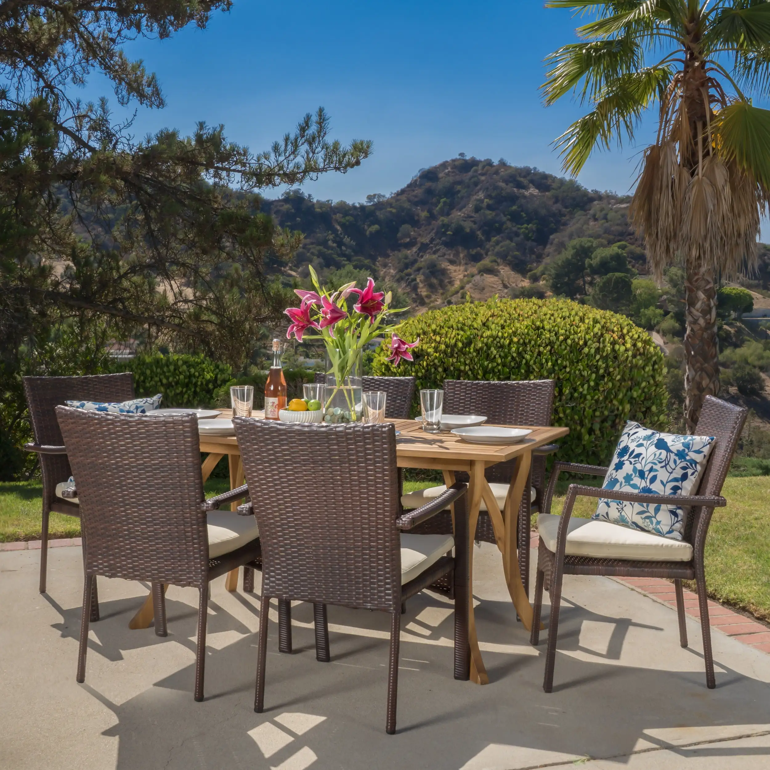 Ruiz 7 Piece Outdoor Wicker and Acacia Wood Dining Set with Cushions. Teak Finish. Creme